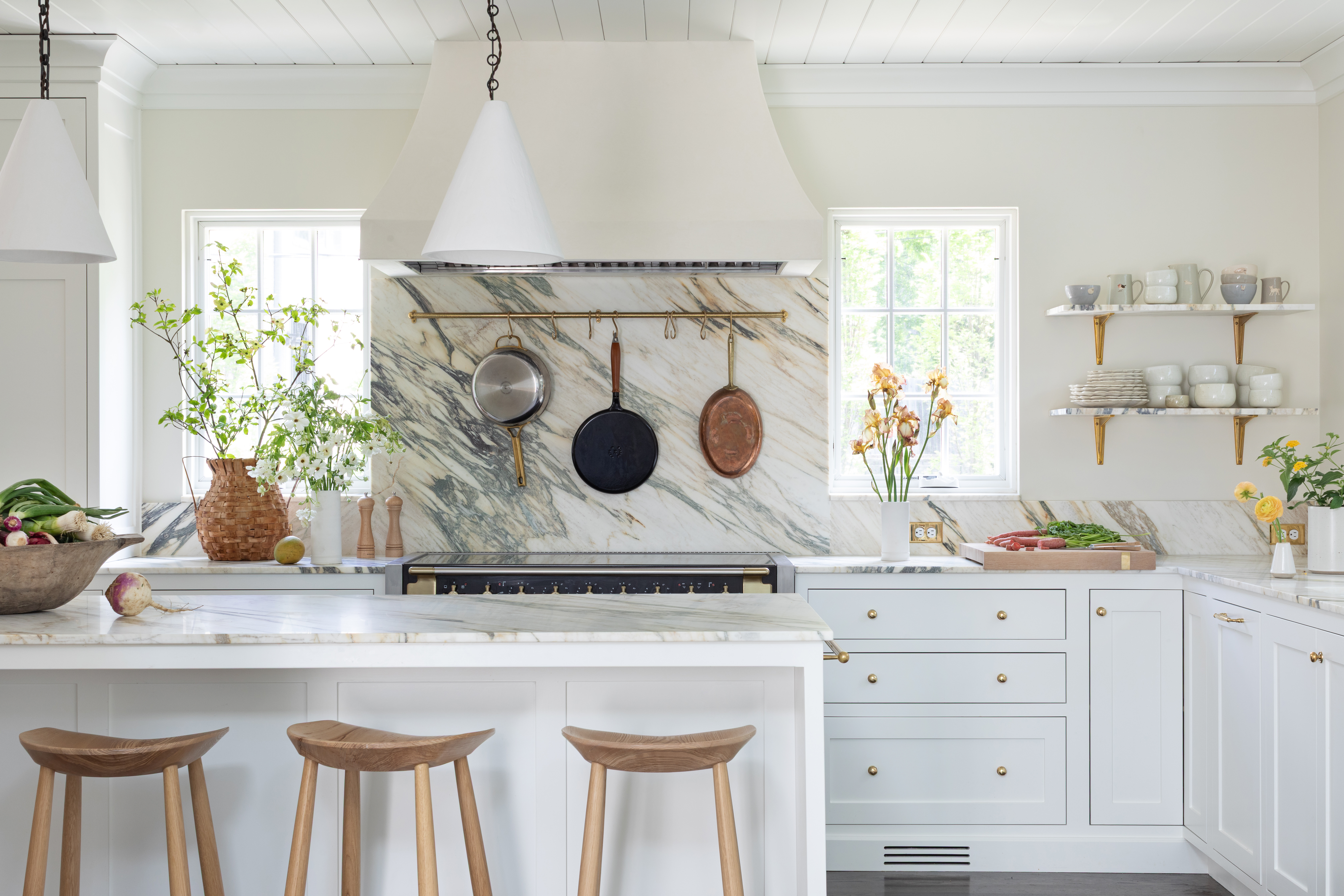 Brookside kitchen remodel with marble backsplash and a custom oven hood.