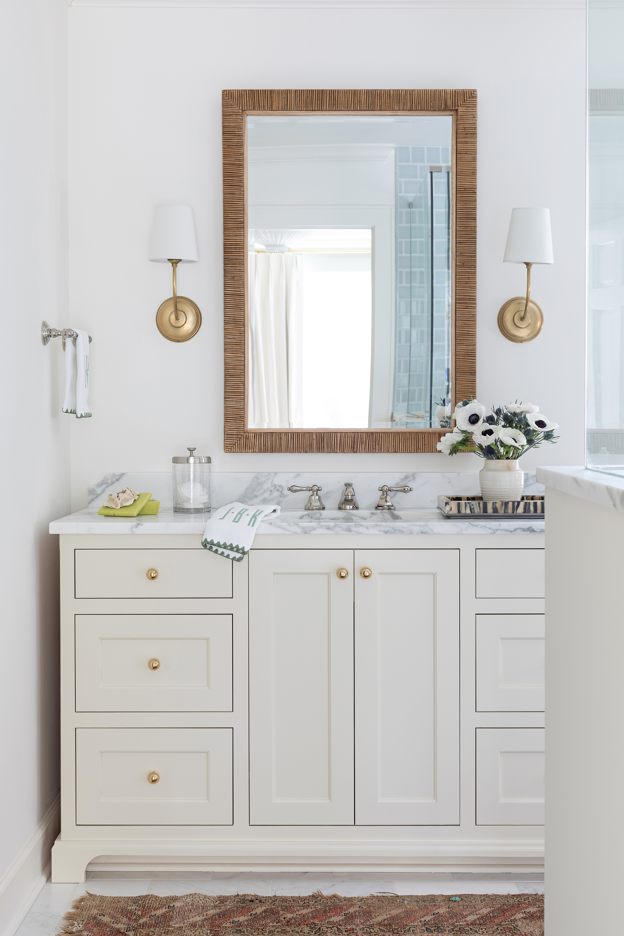 White bathroom vanity with sconces 