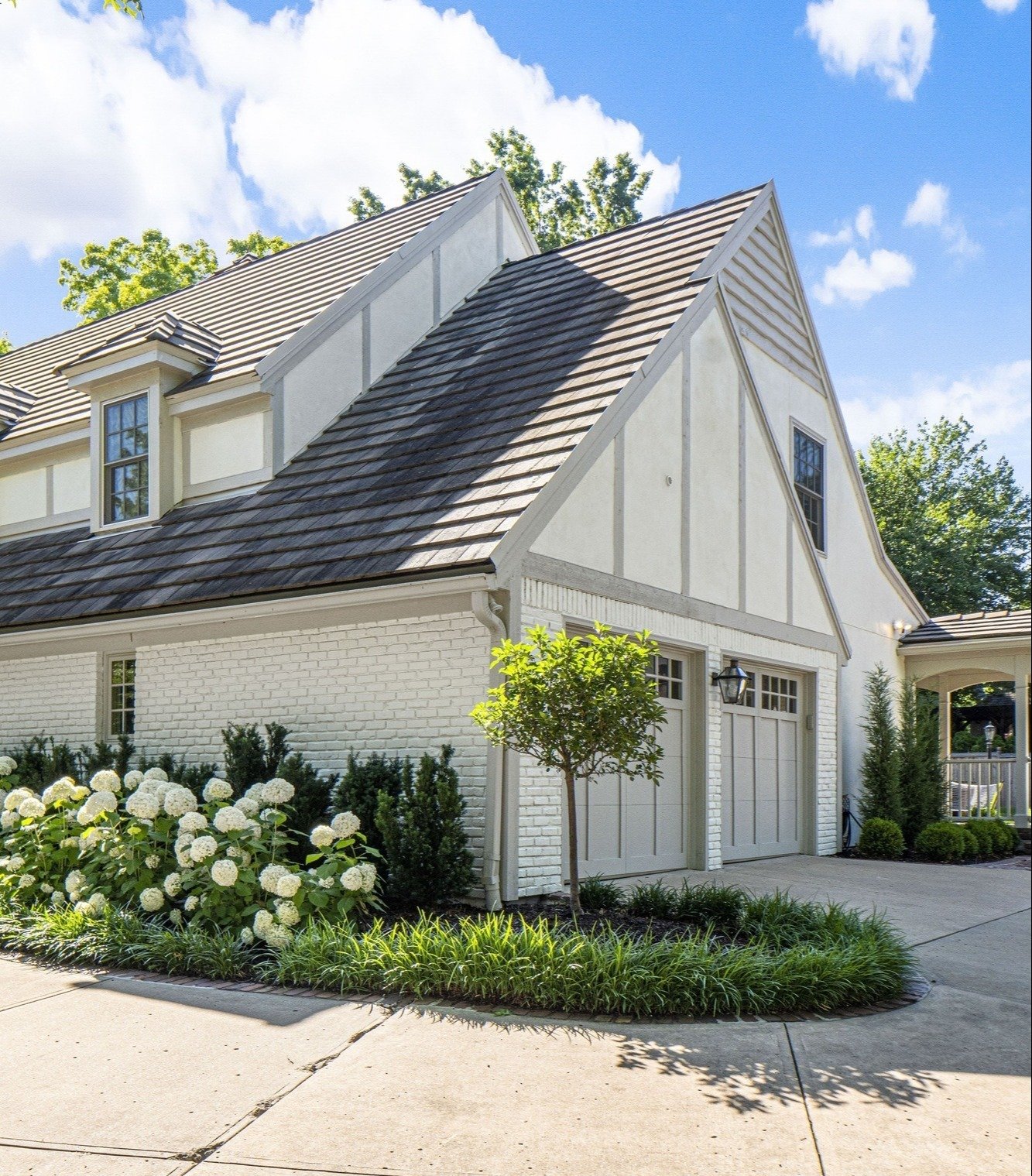Secondary shot of the bay window facade, highlighting the garage and back portico.