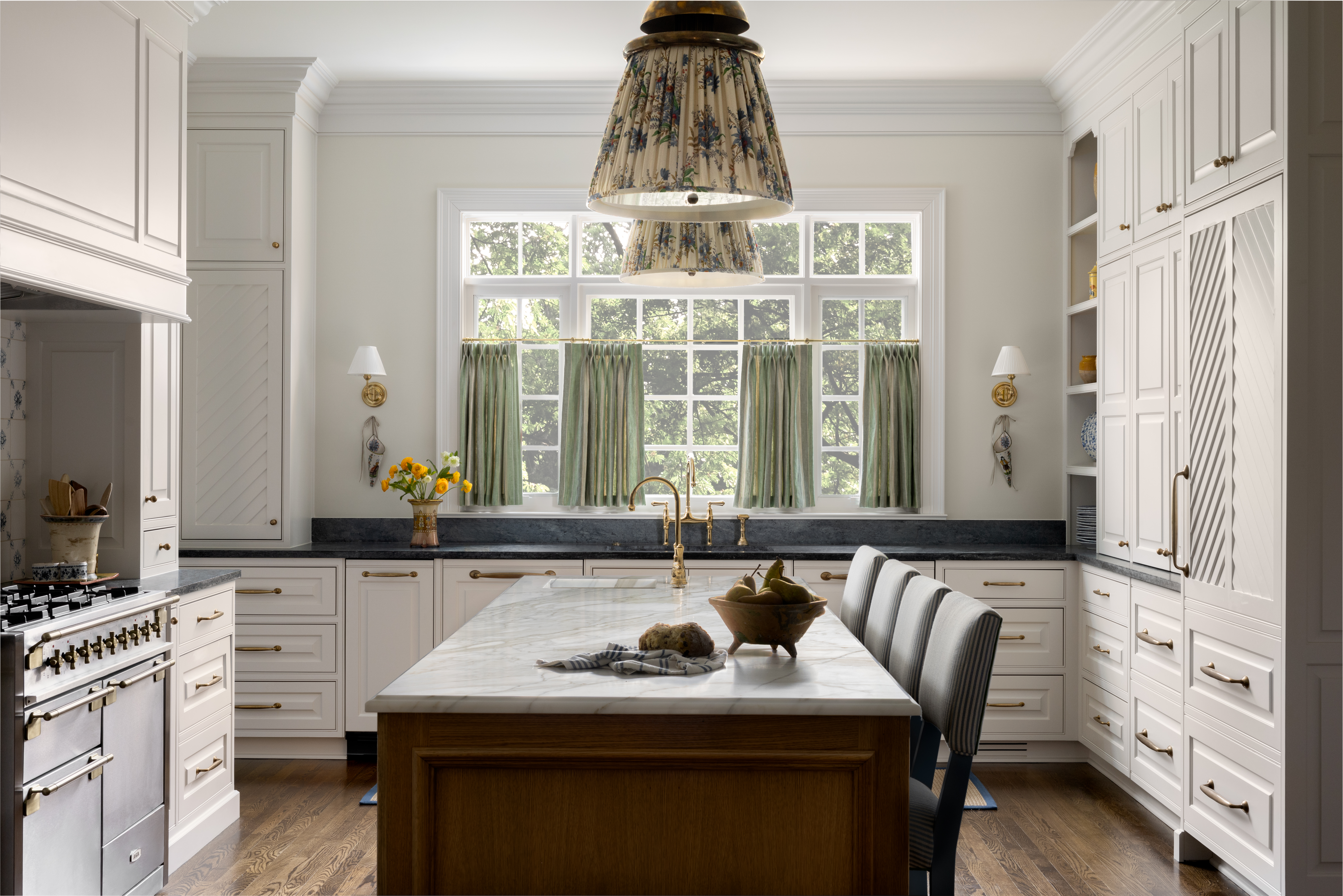 Pretty kitchen with island and light pendants and custom cabinetry 