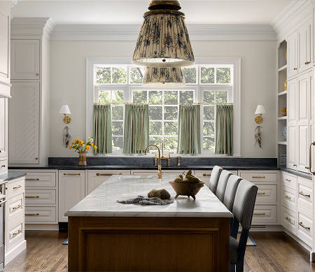 custom designed kitchen with drapes covering the windows and an antique lighting figure